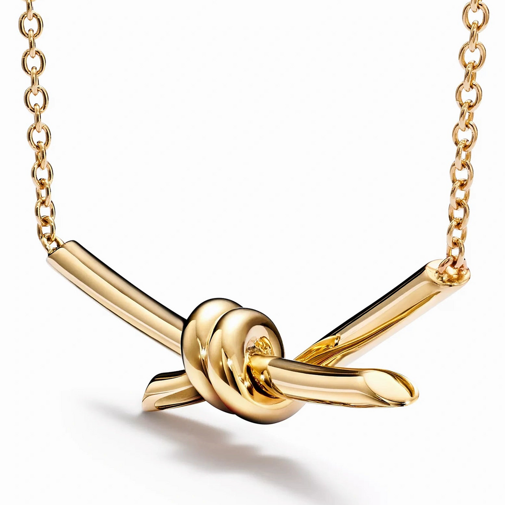 Yellow gold knot pendant necklace