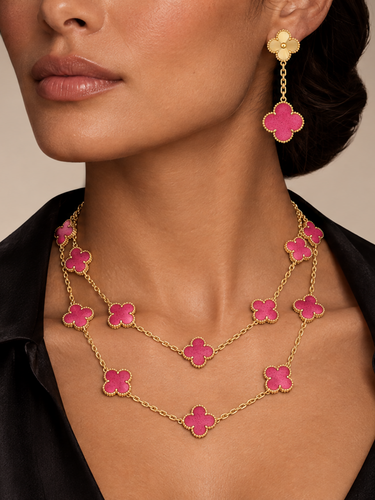Model wearing a pink clover long necklace and matching drop earrings in yellow gold